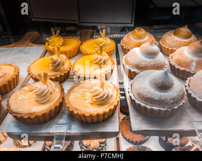 Sweet and beautiful cupcakes in restaurant display window Stock Photo