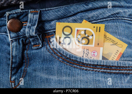 50 Australian dollars bill in front pocket of female blue jeans closeup Stock Photo