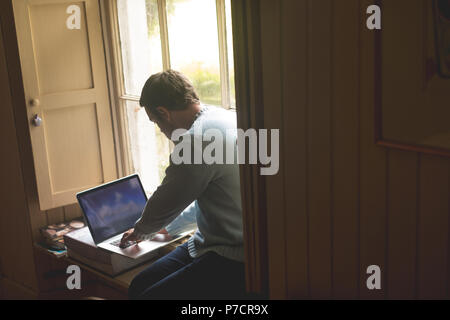 Man using laptop at home Stock Photo