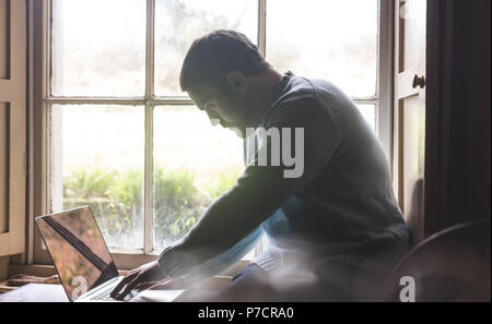 Man using laptop at home Stock Photo
