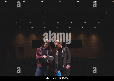 Male and female actress reading script on stage Stock Photo