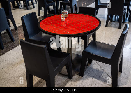 Red round table with black chairs in shopping mall eatery closeup Stock Photo