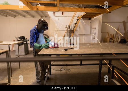 Female welder using welding torch Stock Photo