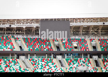 Empty stadium tribunes along with an empty black electronic scoreboard Stock Photo
