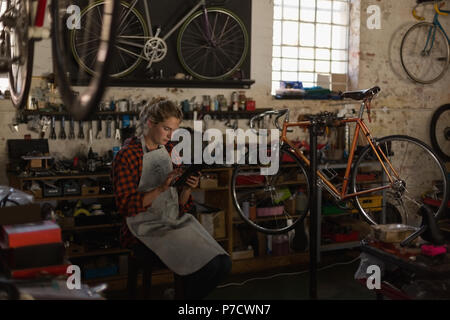 Female mechanic using digital tablet Stock Photo