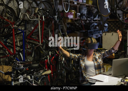 Female mechanic using virtual reality headset Stock Photo