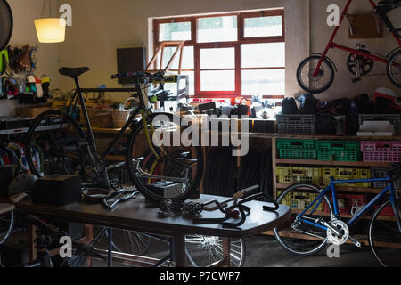 Bicycle and bicycle parts on a table Stock Photo