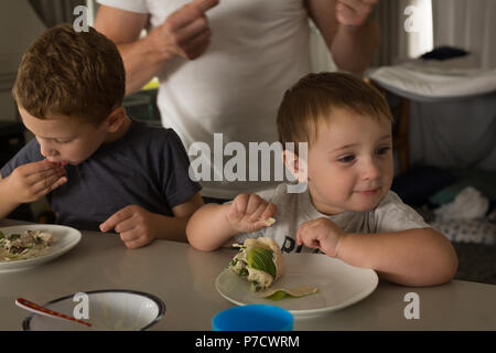 Father and son having breakfast on a dinning table Stock Photo