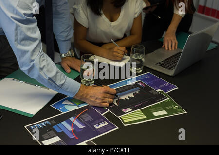 Business colleagues discussing over graph document Stock Photo