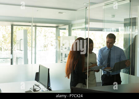 Business colleagues discussing over documents Stock Photo