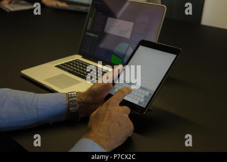 Businessman using digital tablet in conference room Stock Photo