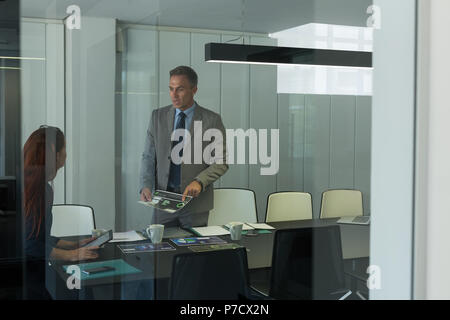 Business colleagues discussing over documents Stock Photo