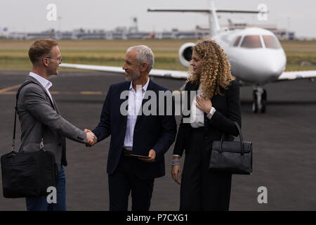 Businesspeople shaking hands with each other Stock Photo