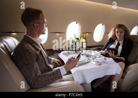 Businesspeople using mobile phone and digital tablet Stock Photo