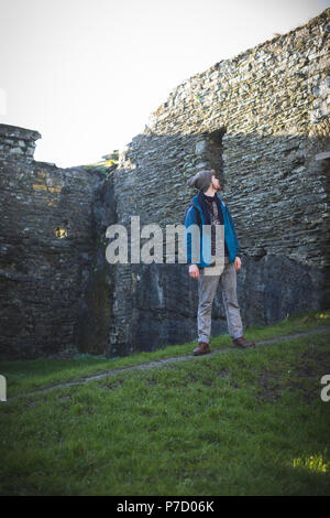 Male hiker standing in old ruin at countryside Stock Photo