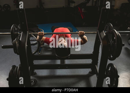 Handicapped man doing chest workout on bench press with barbell Stock Photo