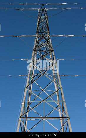 Electricity pylon against blue sky Stock Photo