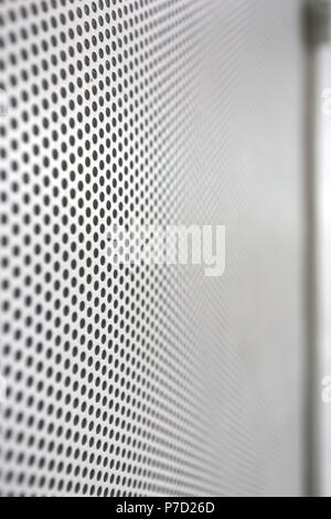 a creative white wall made from hole pattern metallic industrial sheet Stock Photo