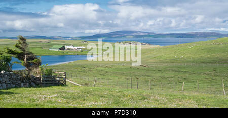 Yell, Shetland landscape, looking over the village of West Sandwick and Loch of Scattland towards Yell Sound and the Shetland mainland near North Roe Stock Photo