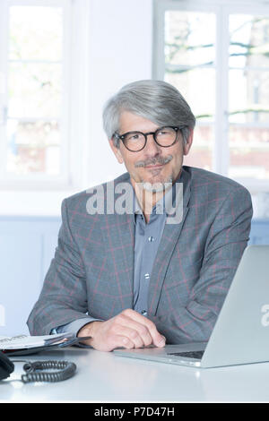 Man working at the laptop in the office Stock Photo