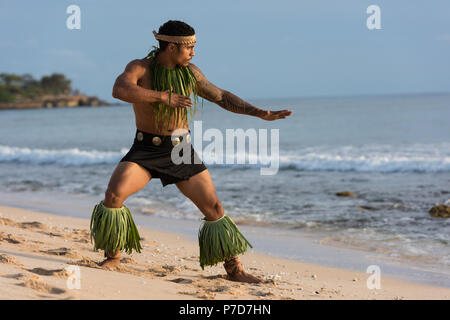 Male fire dancer performing at the beach Stock Photo