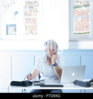 Man working at the laptop in the office Stock Photo
