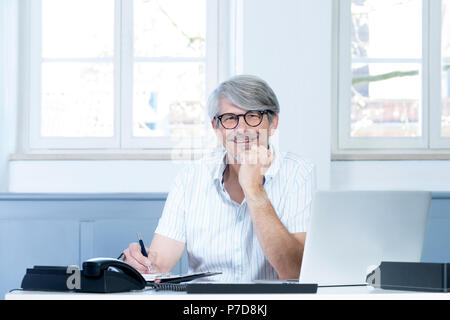 Man working at the laptop in the office Stock Photo