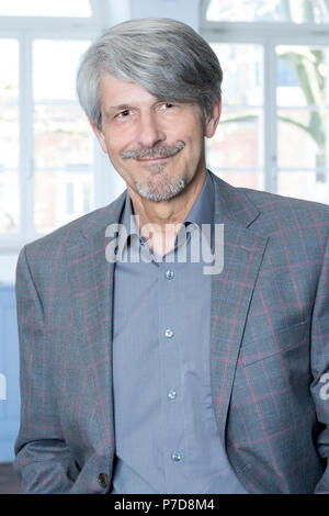 Man standing in front of an office window Stock Photo