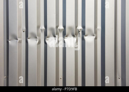 Damaged aluminium cladding on building wall - France. Stock Photo
