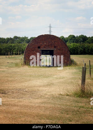 A Nissen hut is a prefabricated steel structure for military use, made from half-cylindrical skin of corrugated steel near Rotherham, South Yorkshire Stock Photo