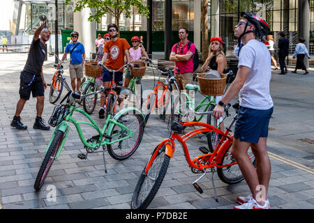 Tourists Stop In ‘The City’ During A Bicycle Tour Of London Sights, London, United Kingdom Stock Photo