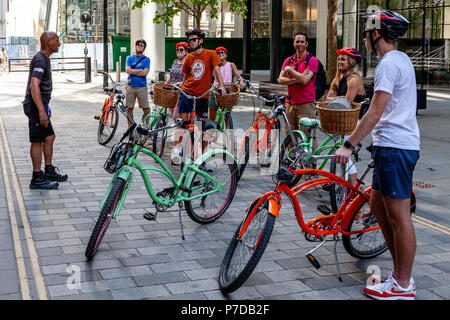 Tourists Stop In ‘The City’ During A Bicycle Tour Of London Sights, London, United Kingdom Stock Photo