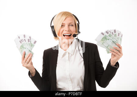 Excited call center operator, blonde woman dressed in black jacket holding euro banknotes Stock Photo