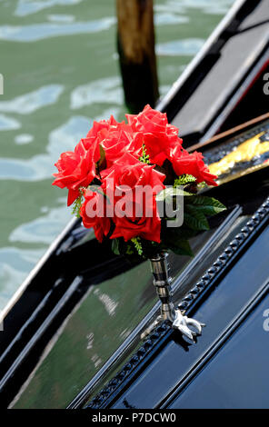 red roses in silver vase on gondola, venice, italy Stock Photo