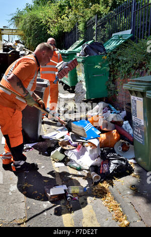 City council workmen cleaning up the fly-tipped rubbish left by students at end of university term, England Stock Photo