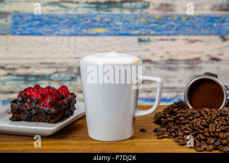 Cappuccino coffee with chocolate sprinkles and strawberry cream sponge cake Stock Photo