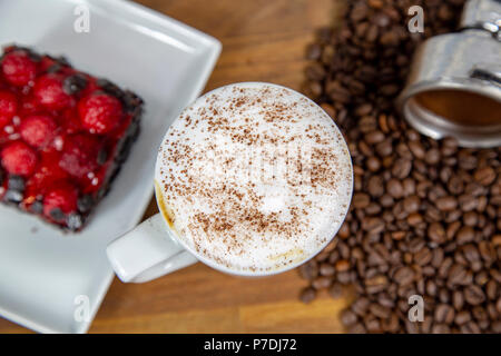 Closeup cappuccino coffee with strawberry cheese cake and coffee beans Stock Photo