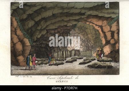 Sepulchral cave with mummies of the Guanche (aboriginal Berber) people on the Canary Islands. Handcoloured copperplate engraving by Andrea Bernieri from Giulio Ferrario's Ancient and Modern Costumes of all the Peoples of the World, Florence, Italy, 1843. Stock Photo