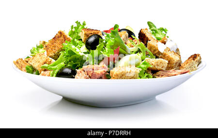 Delicious fresh salad dish on a white plate, isolated on white background. Healthy eating scene, fresh lettuce, tomatoes, tuna, cucumber, roasted brea Stock Photo