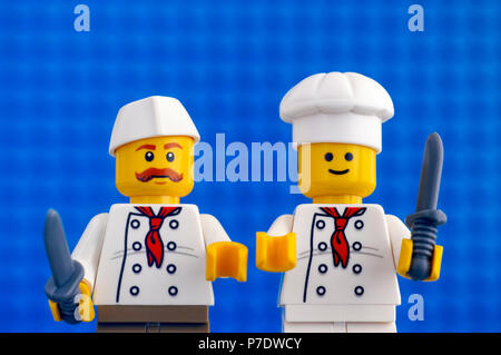 Tambov, Russian Federation - February 05, 2018 Two Lego chefs with knives. Blue baseplate background. Studio shot. Stock Photo
