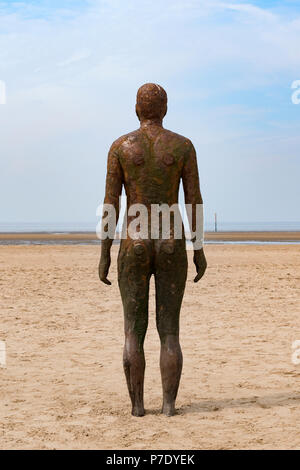 Another Place a modern art installation on crosby beach, liverpool, uk.by sculptor Antony Gormley Stock Photo