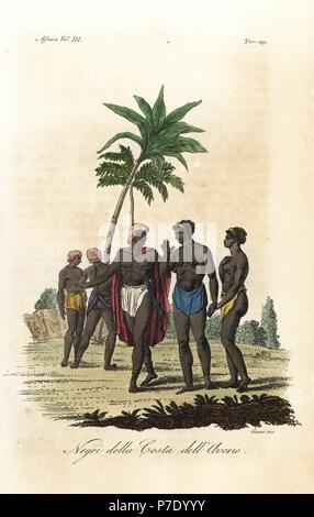 Natives of the Ivory Coast, Africa. Men in loinclothes with hair dyed red and dressed with palm oil, and a noble in cloak. Handcoloured copperplate engraving by Antonio Sasso from Giulio Ferrario's Ancient and Modern Costumes of all the Peoples of the World, Florence, Italy, 1843. Stock Photo