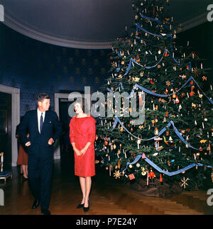 1962 White House Christmas Tree - John and Jacqueline Kennedy 1. 13 December 1961 President and Mrs. Kennedy with the 1961 White House Christmas Tree. White House, Blue Room.  Photograph by Robert Knudsen, Office of the Naval Aide to the President, in the John F. Kennedy Presidential Library and Museum, Boston. Stock Photo