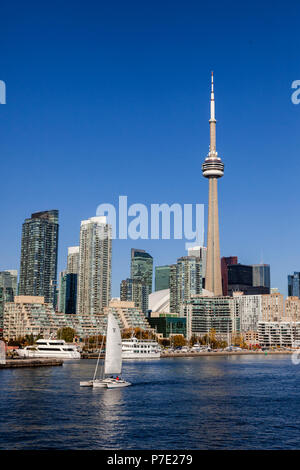 View to the Toronto skyline from Billy Bishop Airport with a sail boat in the foreground. Stock Photo