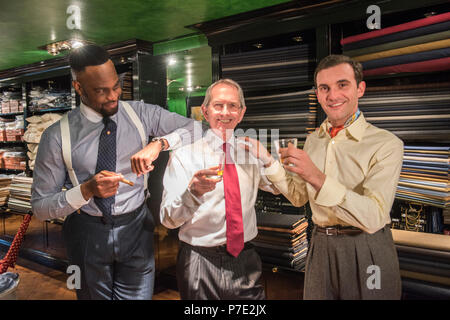 Tailors celebrating in traditional tailors shop, portrait Stock Photo