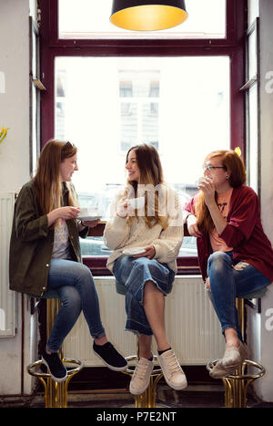 Young women chatting over coffee in cafe Stock Photo