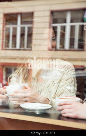 Young woman having coffee in cafe Stock Photo