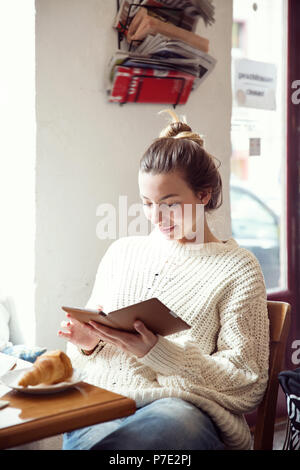 Woman using digital tablet in cafe Stock Photo
