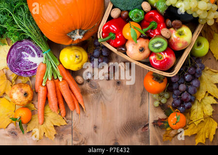 Assortment of fresh and ripe autumn vegetables and fruits on a rustic wooden table. Top view Stock Photo