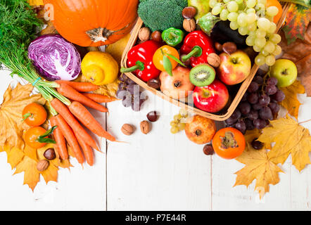 Assortment of fresh and ripe autumn vegetables and fruits on a rustic wooden table. Top view Stock Photo